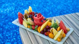 Vassoio ricco di frutta estiva, fonte di fruttosio, sulla poppa di uno yacht
